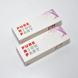 Two white product boxes with a futuristic design, featuring the text "PURE RIOH PART" in bold red and gray letters. The boxes have a subtle purple and starry pattern on the side, placed against a plain white background
