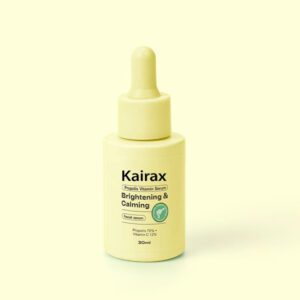 Alt text: A 30ml bottle of Kairax Brightening and Calming Serum with a light yellow dropper cap, featuring a label that reads "Propolis 7.5% + Vitamin Serum" on a light yellow background.