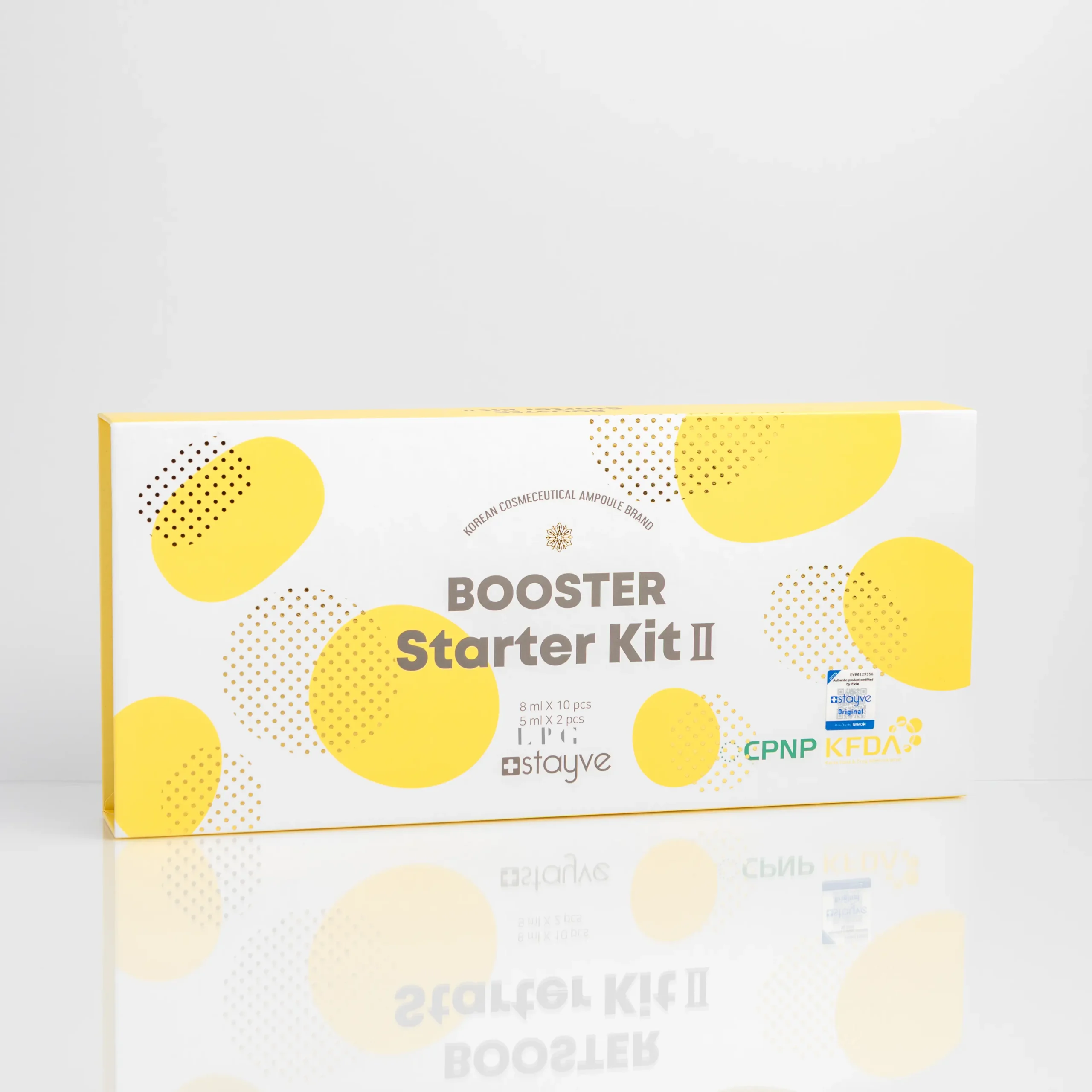 White packaging of "BOOSTER Starter Kit II" with yellow dots, listing contents and certifications on the front.